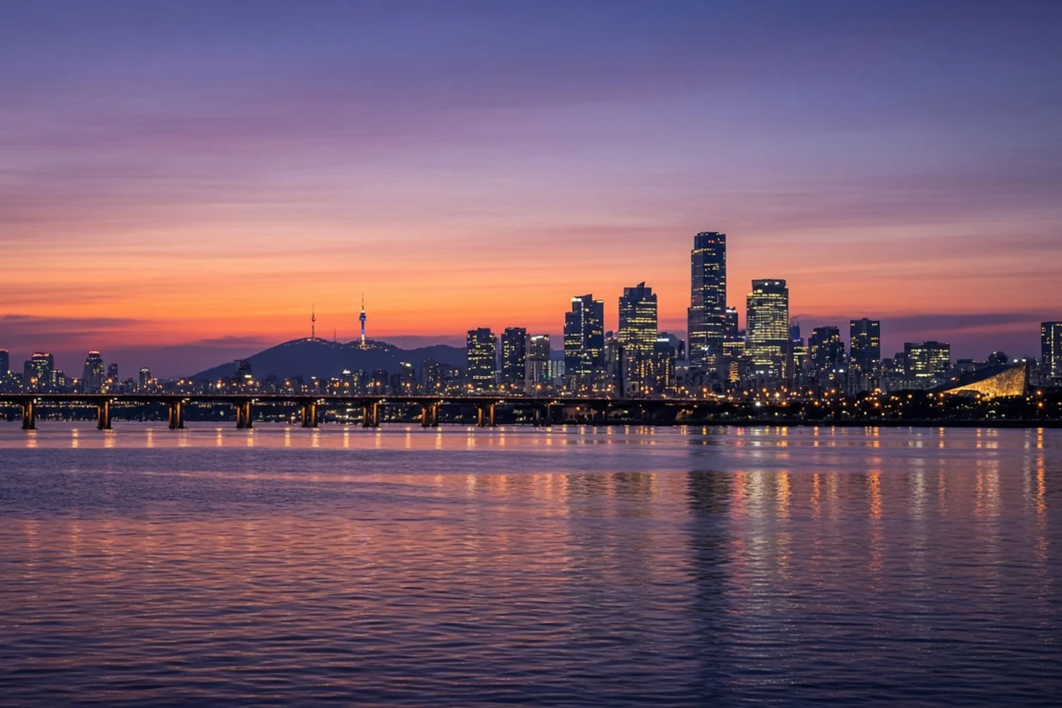Seoul skyline at dusk seen from the Han River, no people, no readable text, no screens